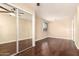 Bedroom featuring hardwood floors, a window, and large closet at 5127 E Tamblo Dr, Phoenix, AZ 85044