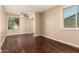 This bedroom features hardwood floors, a ceiling fan, and a window at 5127 E Tamblo Dr, Phoenix, AZ 85044