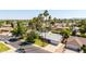 Inviting single-Gathering home with mature trees, a well-manicured lawn, and a spacious driveway at 5127 E Tamblo Dr, Phoenix, AZ 85044