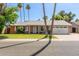 Charming single-story home featuring a well-manicured front yard, a brick facade, and a two-car garage at 5127 E Tamblo Dr, Phoenix, AZ 85044
