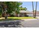 Single-story home with a well-maintained lawn and a two-car garage under a blue sky at 5127 E Tamblo Dr, Phoenix, AZ 85044