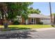 Single-story home with a well-maintained lawn and a two-car garage under a blue sky at 5127 E Tamblo Dr, Phoenix, AZ 85044
