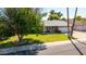 Lovely home with a well-kept lawn, mature tree, and a two-car garage at 5127 E Tamblo Dr, Phoenix, AZ 85044