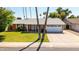 Charming single-story home with well-manicured lawn, mature trees, and a two-car garage at 5127 E Tamblo Dr, Phoenix, AZ 85044