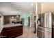 Spacious kitchen with stainless appliances adjacent to a dining area and bonus room at 5127 E Tamblo Dr, Phoenix, AZ 85044