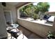 Enjoy outdoor living on this balcony with cozy seating and views of the surrounding neighborhood at 5345 E Van Buren St # 115, Phoenix, AZ 85008