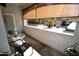 Relax on this covered balcony with comfortable seating and community views at 5345 E Van Buren St # 115, Phoenix, AZ 85008