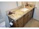 Bathroom vanity with a granite countertop, dark wood cabinets, and sink at 5345 E Van Buren St # 115, Phoenix, AZ 85008