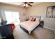 Bright bedroom with a ceiling fan and access to a balcony with an orange chair at 5345 E Van Buren St # 115, Phoenix, AZ 85008