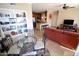 Charming dining area with a glass table, decorative shelving, and an open view into the kitchen at 5345 E Van Buren St # 115, Phoenix, AZ 85008