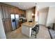Well-equipped kitchen boasts a large island with seating, stainless steel appliances, and ample cabinetry at 5345 E Van Buren St # 115, Phoenix, AZ 85008