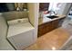 Modern laundry area with wooden cabinets, granite countertops, and stainless steel dishwasher at 5345 E Van Buren St # 115, Phoenix, AZ 85008
