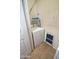 Cozy laundry room featuring a white washing machine and shelves for storage at 5345 E Van Buren St # 115, Phoenix, AZ 85008