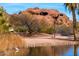 Picturesque park lake with a white heron and views of Papago Park's iconic red rock formations in the background at 5345 E Van Buren St # 115, Phoenix, AZ 85008