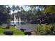 Scenic pond with fountains, palm trees, and rock features creating a tranquil outdoor space at 5345 E Van Buren St # 115, Phoenix, AZ 85008