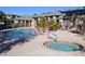 Community pool and spa area with sun loungers, lush landscaping, and a serene environment for relaxation and recreation at 5345 E Van Buren St # 115, Phoenix, AZ 85008