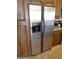 Stainless steel refrigerator and brown cabinetry in the kitchen at 5345 E Van Buren St # 115, Phoenix, AZ 85008