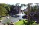 Picturesque water feature with cascading waterfalls, lush greenery, and palm trees, creating a tranquil outdoor space at 5345 E Van Buren St # 115, Phoenix, AZ 85008