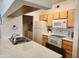 Bright kitchen featuring modern countertops, white appliances, and ample cabinet space at 5345 E Van Buren St # 116, Phoenix, AZ 85008