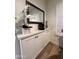 Coffee bar with sleek cabinets and a countertop featuring a mirror and floral arrangement at 5345 E Van Buren St # 216, Phoenix, AZ 85008
