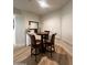 Cozy dining area with a wood table and four high-backed chairs near shuttered windows at 5345 E Van Buren St # 216, Phoenix, AZ 85008