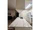 Bright, open kitchen with an island, white cabinetry, and stainless steel appliances at 5345 E Van Buren St # 216, Phoenix, AZ 85008