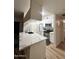 Modern kitchen featuring a white countertop island and stainless steel appliances at 5345 E Van Buren St # 216, Phoenix, AZ 85008