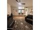 Living room featuring modern furniture, wood flooring, and open view to the kitchen with breakfast bar seating at 5345 E Van Buren St # 216, Phoenix, AZ 85008