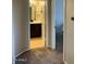 Hallway leading to bedroom and bathroom with carpet flooring and neutral paint at 5345 E Van Buren St # 370, Phoenix, AZ 85008