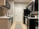 Modern kitchen featuring stainless steel appliances, dark cabinetry, and white countertops at 5345 E Van Buren St # 370, Phoenix, AZ 85008