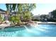 Community pool area with cascading water features, mature landscaping, and lounge chairs at 5345 E Van Buren St # 370, Phoenix, AZ 85008