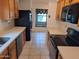 Kitchen with wooden cabinets and appliances with view to window at 7420 W Morrow Dr, Glendale, AZ 85308