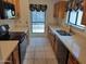 Efficient kitchen with neutral countertops and wooden cabinetry at 7420 W Morrow Dr, Glendale, AZ 85308