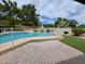 Backyard pool with white fencing, surrounded by a brick patio and lush green grass, perfect for outdoor relaxation and entertainment at 7420 W Morrow Dr, Glendale, AZ 85308