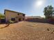 Expansive backyard features gravel landscaping, a small palm tree, and a covered patio area at 8022 S 48Th Dr Dr, Laveen, AZ 85339