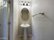 Half-bath featuring pedestal sink, decorative mirror, lighting, and tile flooring at 8022 S 48Th Dr Dr, Laveen, AZ 85339
