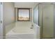 Bathtub and glass shower stall with window at 8022 S 48Th Dr Dr, Laveen, AZ 85339