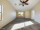 Well-lit bedroom with neutral carpet, a ceiling fan, and large windows for ample light at 8022 S 48Th Dr Dr, Laveen, AZ 85339