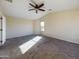 Bedroom featuring neutral carpet, a ceiling fan, and a sunny window view at 8022 S 48Th Dr Dr, Laveen, AZ 85339