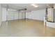 Clean, spacious two-car garage with epoxy flooring, white walls, and ample room for parking and storage at 8022 S 48Th Dr Dr, Laveen, AZ 85339