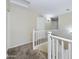 View of the upstairs hallway featuring carpet, white railing and trim, and access to rooms at 8022 S 48Th Dr Dr, Laveen, AZ 85339