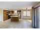 The kitchen has wooden cabinets, stainless steel refrigerator, and an island, with tile flooring at 8022 S 48Th Dr Dr, Laveen, AZ 85339