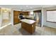 Kitchen featuring stainless steel refrigerator, wooden cabinets, and a kitchen island at 8022 S 48Th Dr Dr, Laveen, AZ 85339