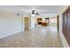 This open-concept living space features tile floors, a ceiling fan, and easy kitchen access at 8022 S 48Th Dr Dr, Laveen, AZ 85339