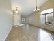 Living room featuring tiled floors, natural light, and modern light fixtures at 8022 S 48Th Dr Dr, Laveen, AZ 85339