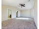 Spacious main bedroom featuring a ceiling fan, neutral carpeting, and en-suite bathroom at 8022 S 48Th Dr Dr, Laveen, AZ 85339