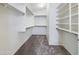 Walk-in closet with ample shelving and rod space for organized storage, and neutral carpet at 8022 S 48Th Dr Dr, Laveen, AZ 85339