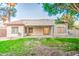 A view of the home's backyard with a large lawn and covered patio at 836 N Sinova Ave, Gilbert, AZ 85234