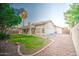 View of the backyard and patio with a spacious lawn area at 836 N Sinova Ave, Gilbert, AZ 85234