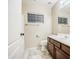 Clean, well-maintained bathroom with a single vanity, wood cabinets, and a shower-tub combination at 836 N Sinova Ave, Gilbert, AZ 85234